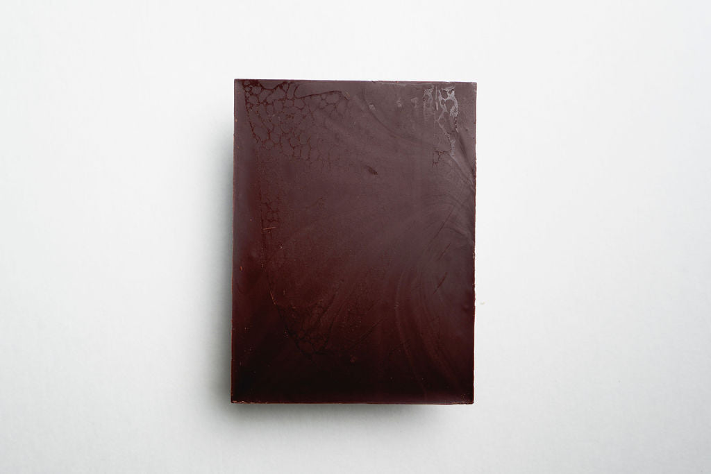 Dark brown chocolate bar on a white background